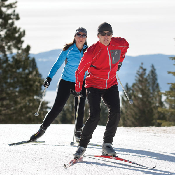 Man and woman cross country skiing