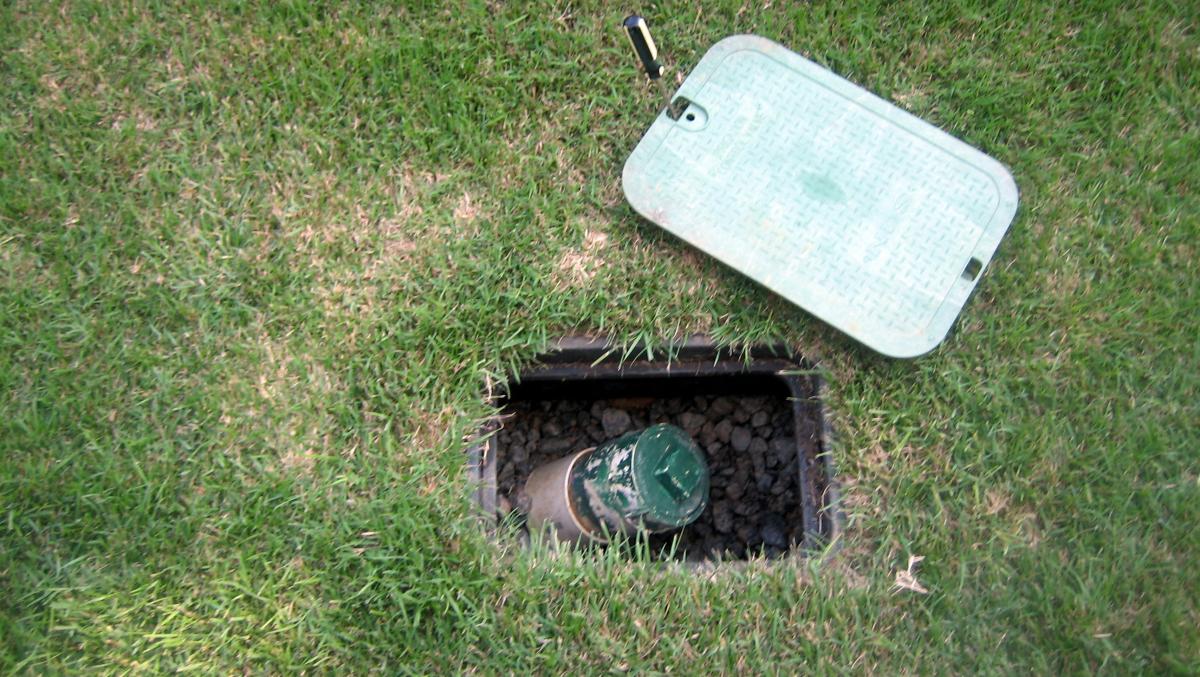 Open sewer cleanout in the grass