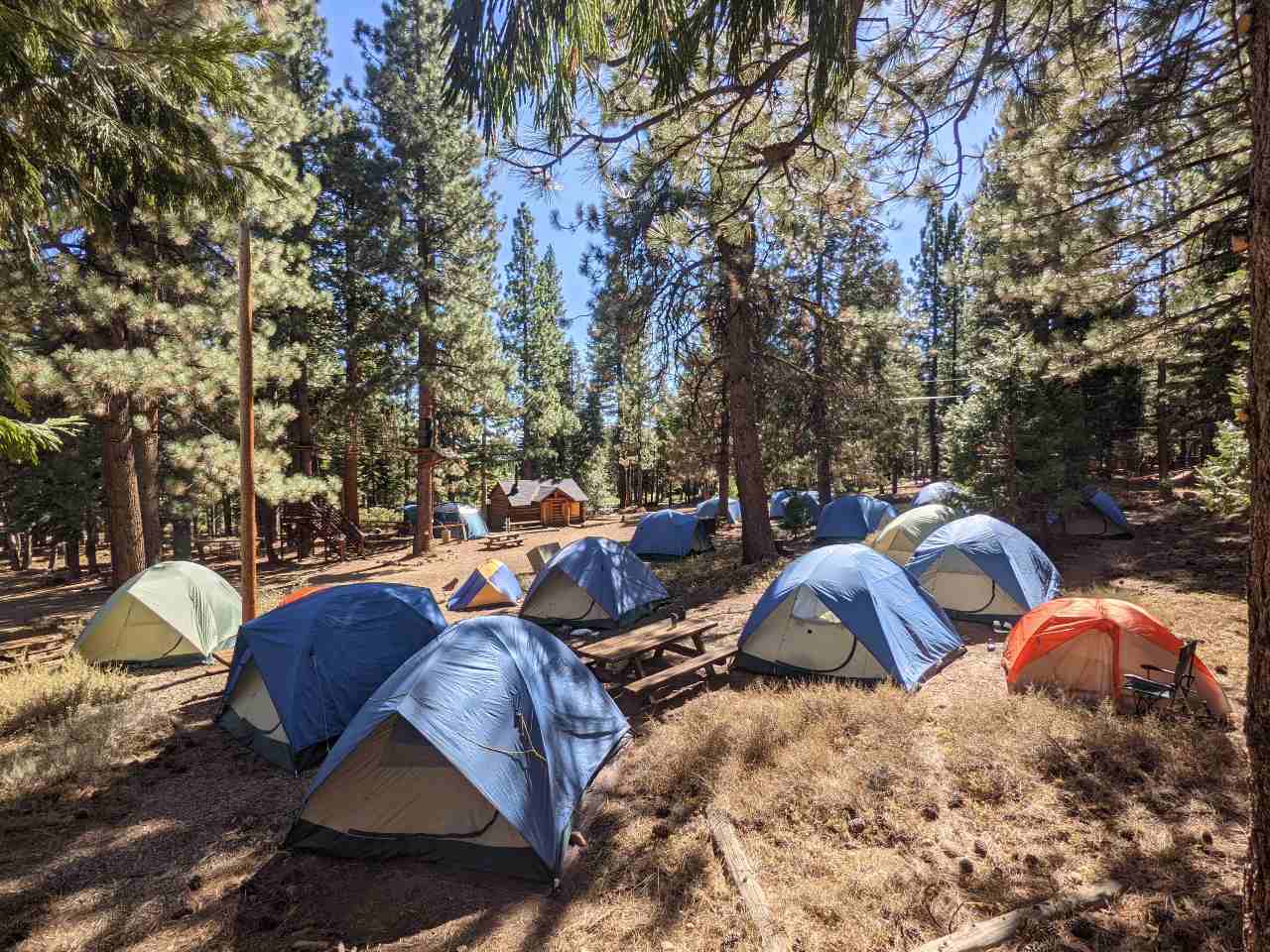 Tents set up outside of Lewellen Scout Cabin