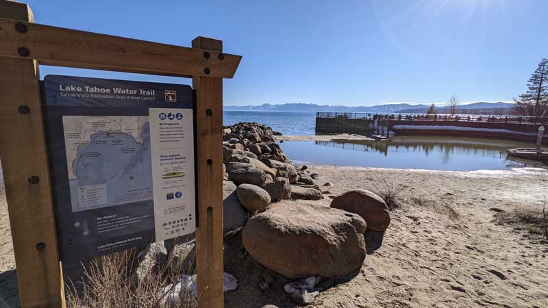 sign and beach at boat launch