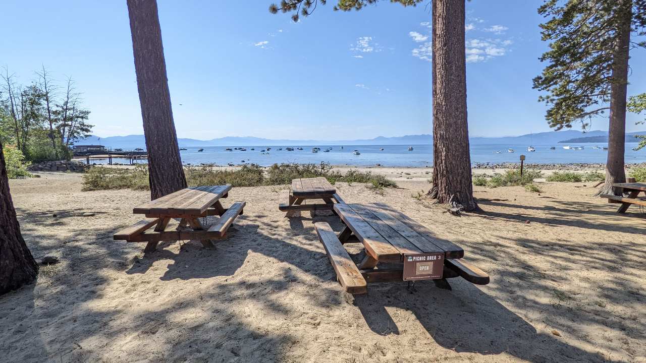 TVRA picnic area benches in the sandy shore of Lake Tahoe